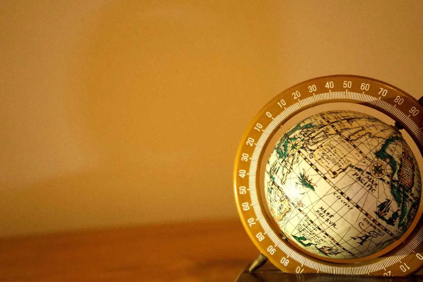 Antique brass globe, symbolising the group's reach across industries
